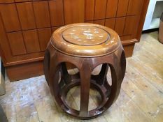 A Chinese hardwood circular stool, the seat with mother of pearl and abalone shell inlay depicting