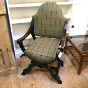 An Aesthetic movement ebonised Curule chair, with geometric carving to arms, later tartan