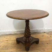 A reproduction mahogany centre table of small proportions, the circular crossbanded top with moulded