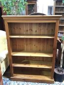 A modern pine open bookcase fitted three adjustable shelves, on plinth base (137cm x 96cm x 29cm)