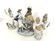 A collection of Lladro figures including Boy with Shoe and Kitten (15cm x 16cm x 10cm), a Girl