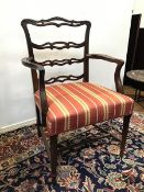 A reproduction mahogany Georgian style open armchair, with pierced and moulded top rail and back