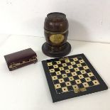 A late Victorian travelling folding chessboard (15cm x 15cm) with a collection of chess pieces (a/f)