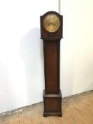 An oak 1920s grandmother clock with domed top above a metal dial with arabic numerals, with