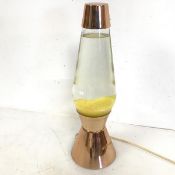 A 1960s/70s lava lamp, with copper top and conical base, with yellow lava (43cm x 13cm to base)