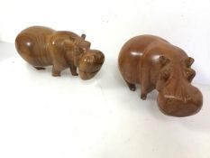 A pair of carved hardwood hippopotamuses (14cm x 26cm x 14cm)