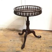 A reproduction Georgian inspired wine table with baluster gallery edge on turned support and