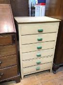 A 1950s/60s bank of drawers, painted in a light yellow with green pulls, six drawers, on straight