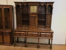 An oak late Victorian dresser in early 18thc style, with a central clock marked Torkington,