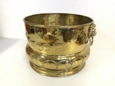 A modern brass planter with lion masks to side and drop handles (24cm x d.38cm)