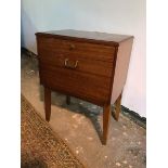 A Lebus teak mid century bedside cabinet with single frieze drawer above a drop front cupboard, on