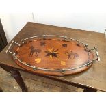 A 1960s drinks tray with raised gallery and handles to side above an oval tray with marquetry