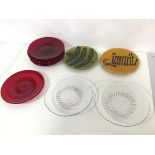Two small coloured plates with raised painted decoration, marked Margery Clinton, Scotland (15cm),