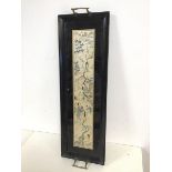 An ebonised drinks tray, with bamboo inspired handles to side, with central panel of Japanese