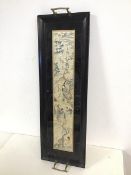 An ebonised drinks tray, with bamboo inspired handles to side, with central panel of Japanese