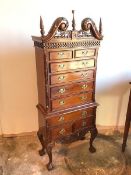 A modern mahogany Federal style chest on frame with broken swan neck and foliate crest above blind