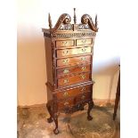 A modern mahogany Federal style chest on frame with broken swan neck and foliate crest above blind