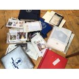 A tub containing a collection of Royal themed First Day covers and stamps, some loose, mainly mint