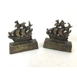 A pair of brass doorstops, both in the form of a sailing warship and inscribed verso, A Galleon in