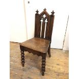 A Victorian Gothic Revival oak hall chair with pierced splat over a solid seat, on bobbin turned