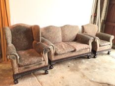 A 1920s/30s suite including a two seater sofa and lady's and gentleman's armchairs, all with