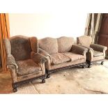 A 1920s/30s suite including a two seater sofa and lady's and gentleman's armchairs, all with