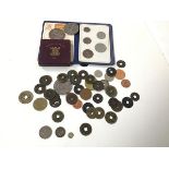 A collection of coins including a George III five pence, a small Queen Victoria token inscribed with
