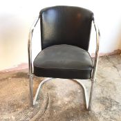 A tubular steel framed cantilever open armchair with black leather upholstered back and seat (80cm x