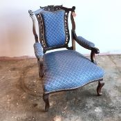 A Victorian open armchair with moulded top rail above upholstered splats flanked by acanthus leaves,
