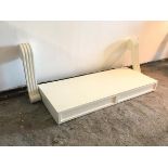 A modern white console table, the rectangular top fitted two frieze drawers, on chanelled corbel