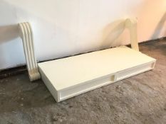 A modern white console table, the rectangular top fitted two frieze drawers, on chanelled corbel