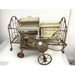 A collection of children's toys including a metal framed doll's bed on castors (40cm x 65cm x 37cm),