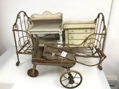 A collection of children's toys including a metal framed doll's bed on castors (40cm x 65cm x 37cm),