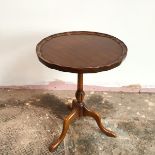 A modern Georgian style wine table, with piecrust edge, on turned support with tripod base (52cm x