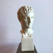 A plaster bust of a male classical figure, on square base (60cm)