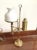 A c.1900 student's oil lamp, with milk glass shade and gas cannister to one side, on
