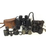 A collection of binoculars including a Tohyoh, a small pair of Edwardian binoculars with metal