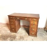 A late 19thc mahogany pedestal desk, with moulded top above dummy central frieze drawer, flanked