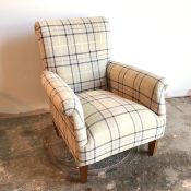 A modern armchair with scroll headrest and arms in ivory and blue tartan upholstery, on tapering