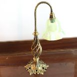 An Edwardian brass table lamp with ruffled vaseline glass shade, on spiral body with foliate base (