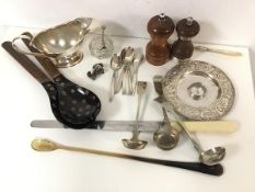 A mixed lot including a white metal candlestick, a bone handled carving knife and stirring spoon,