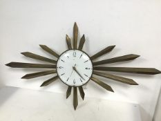 A Metamec metal sunburst clock, battery operated, minute hand slightly bent (48cm x 87cm)