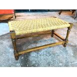 An oak footstool with woven top on turned supports united by box stretcher (29cm x 59cm x 30cm)