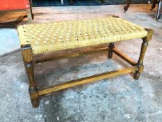 An oak footstool with woven top on turned supports united by box stretcher (29cm x 59cm x 30cm)