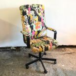 An office chair upholstered in an Indian inspired fabric, depicting figures on horseback and