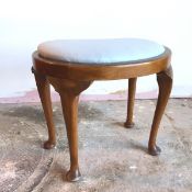 A kidney shaped footstool with light blue upholstered drop in top, on cabriole supports