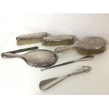 An Edwardian London silver toiletry set including hairbrush, hand mirror, clothes brushes, shoe