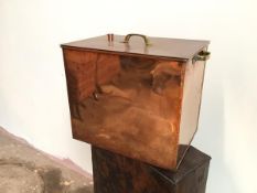 A metal box with copper exterior, the lift off lid with aperture, with brass handles to top and