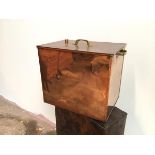 A metal box with copper exterior, the lift off lid with aperture, with brass handles to top and