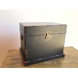 A modern ebonised Chinese chest, the hinged top with a butterfly latch, with drop handles to